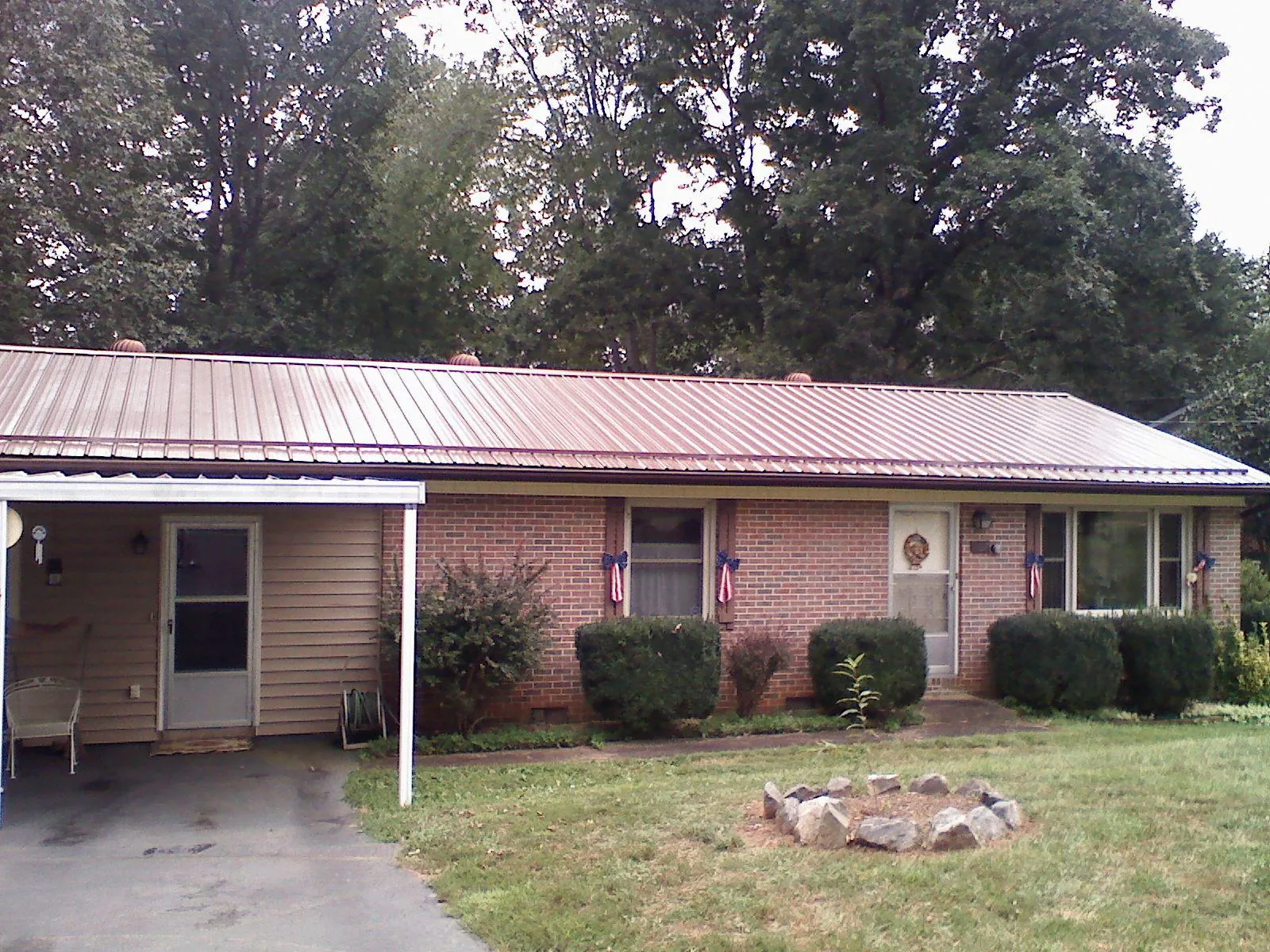 Bronze metal roof and carport on a brick ranch home — Roof Repair work by our crew in Port Deposit